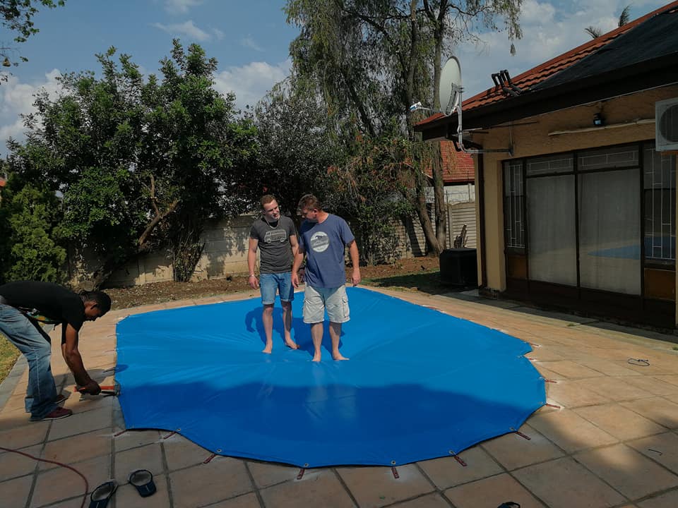 pool safety net specialist two men standing on pool safety cover